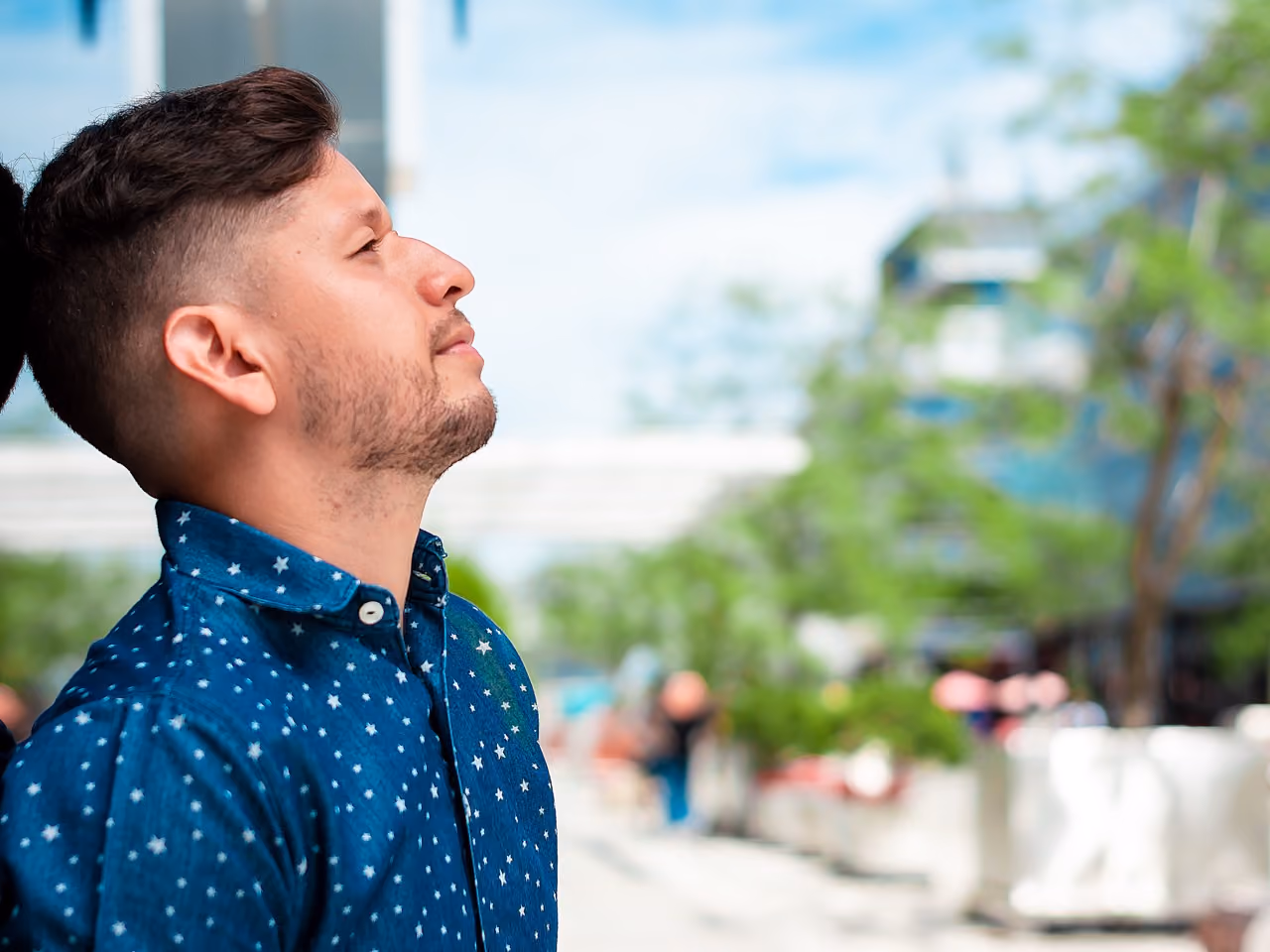 Person leaning on wall and looking off into the distance