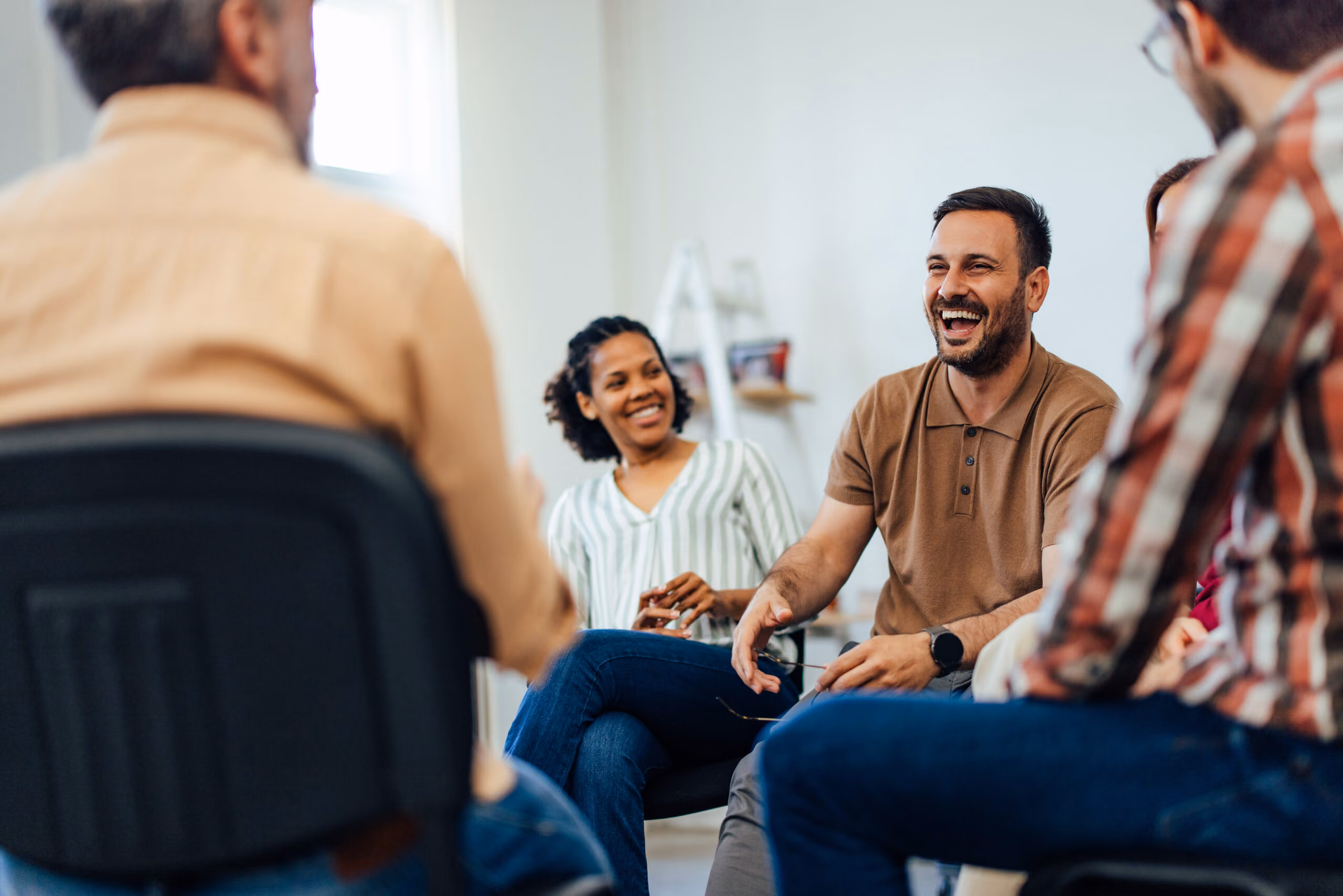 People smiling while seated in a group