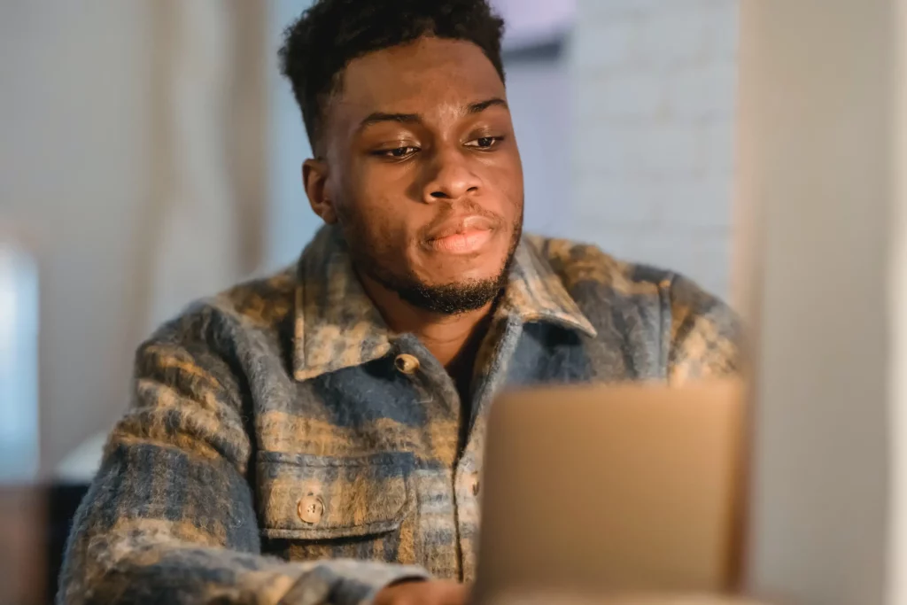 A man using a laptop sat at a desk