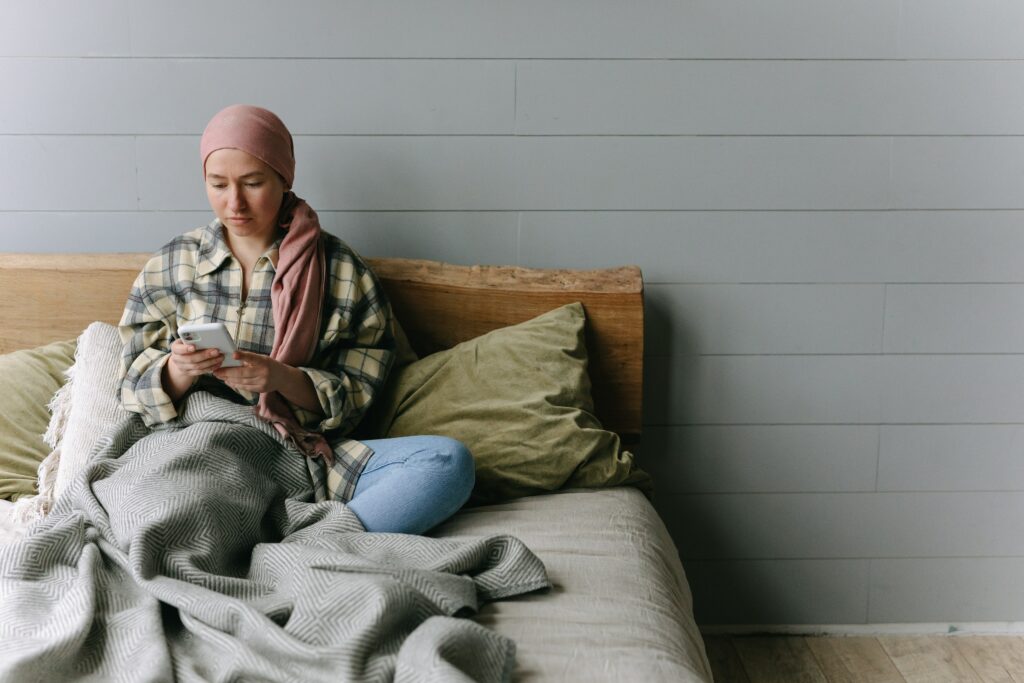A woman in bed looking at her phone