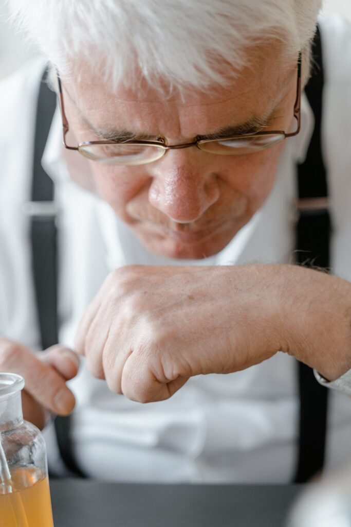 Man in lab smelling a substance