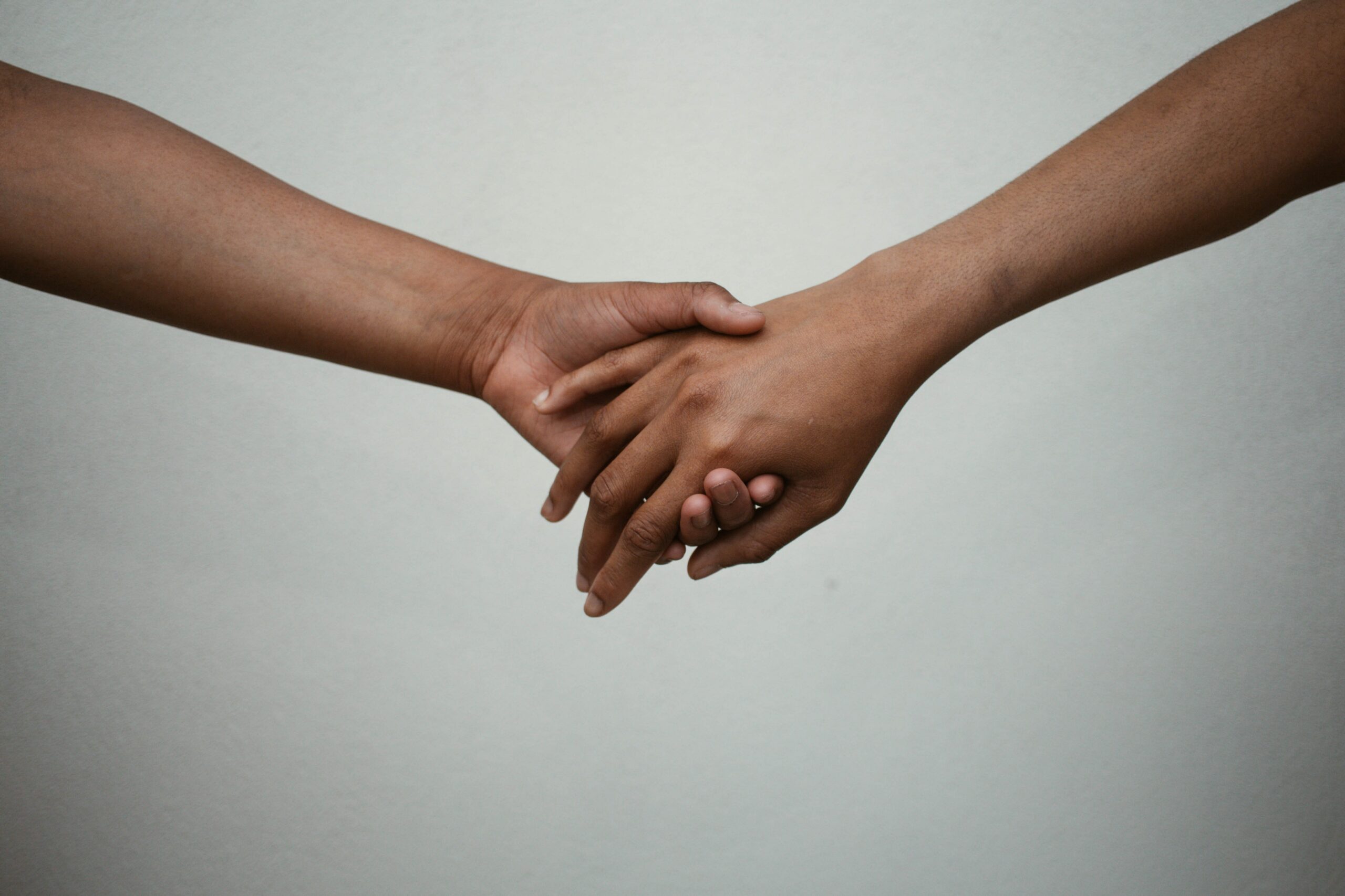 Two people holding hands