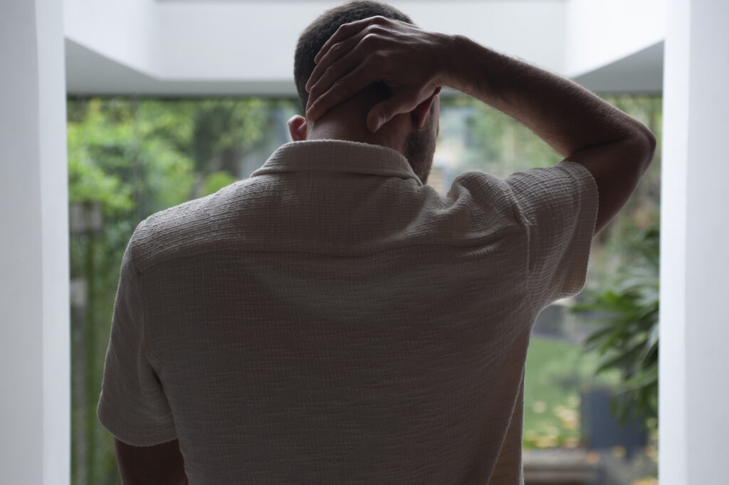 A man holding his neck