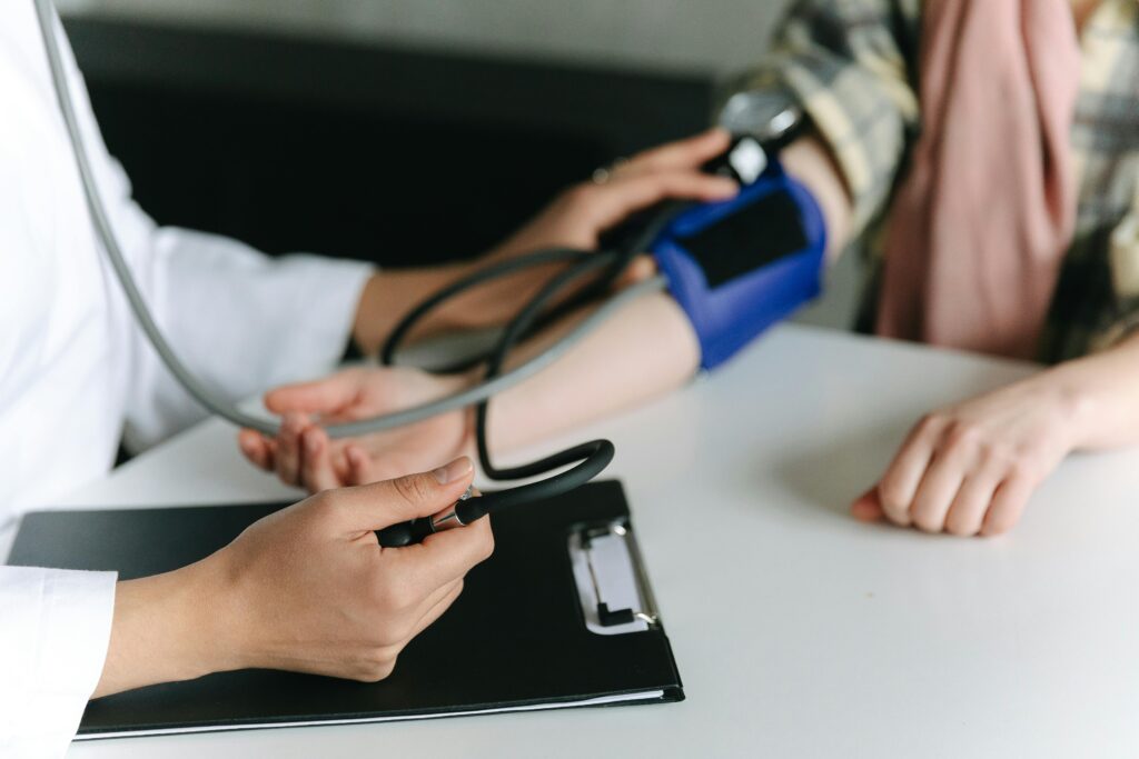 A doctor takes the blood pressure of a patient