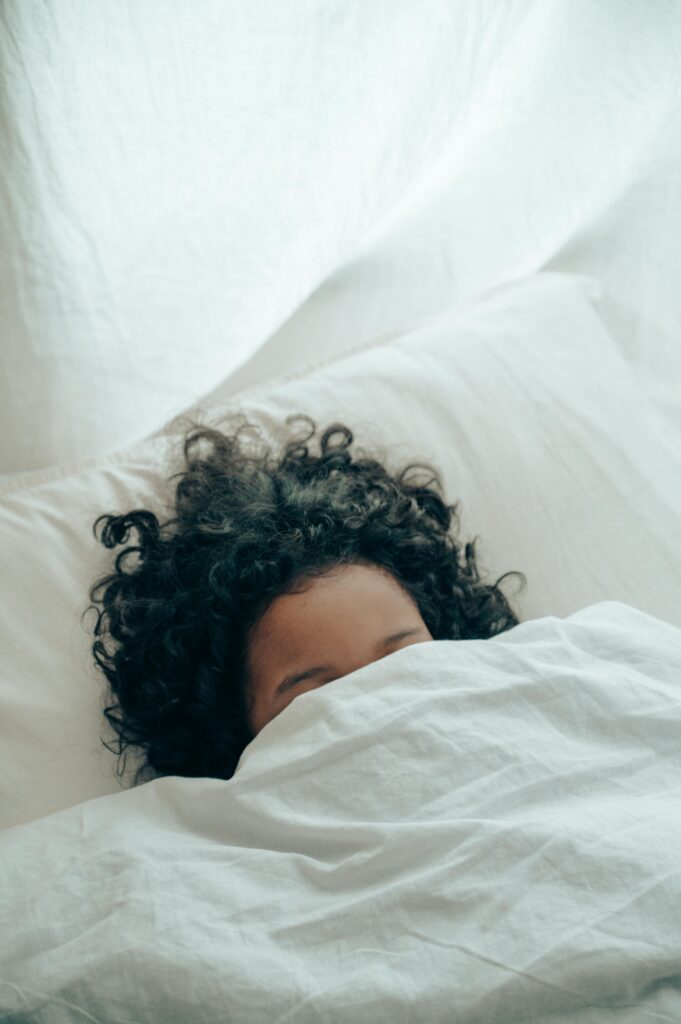 A woman snug under a thick winter duvet