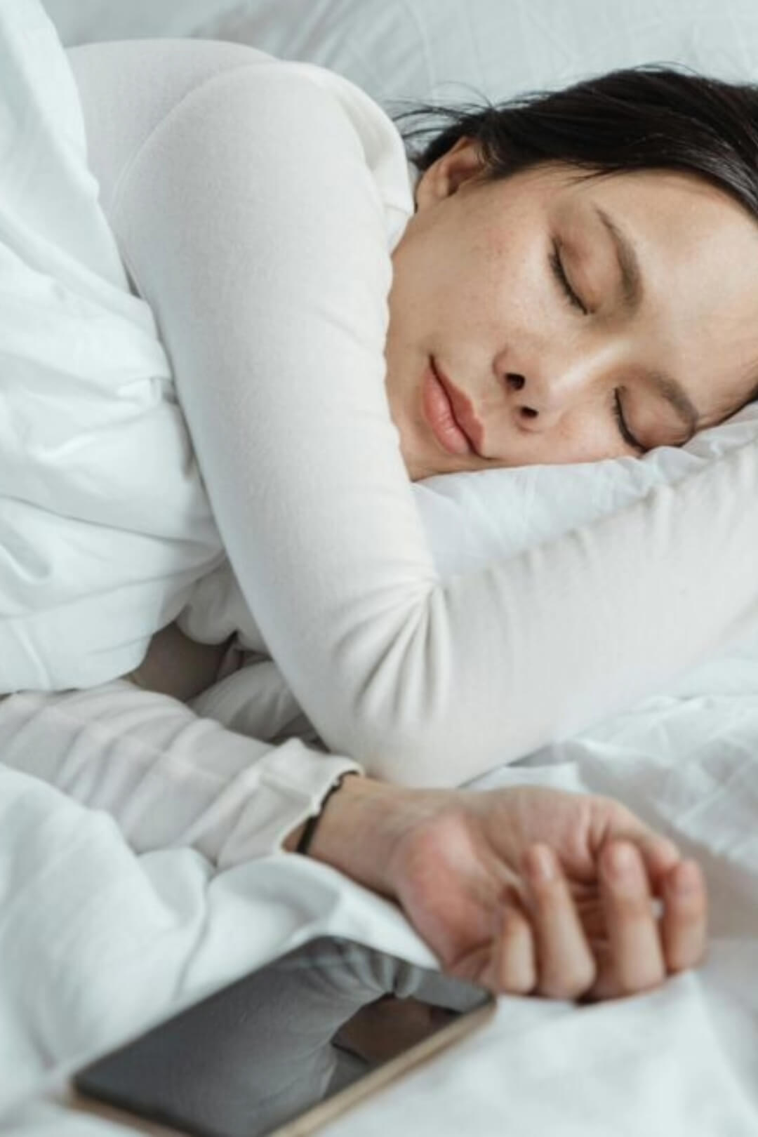A woman sleeping soundly in bed