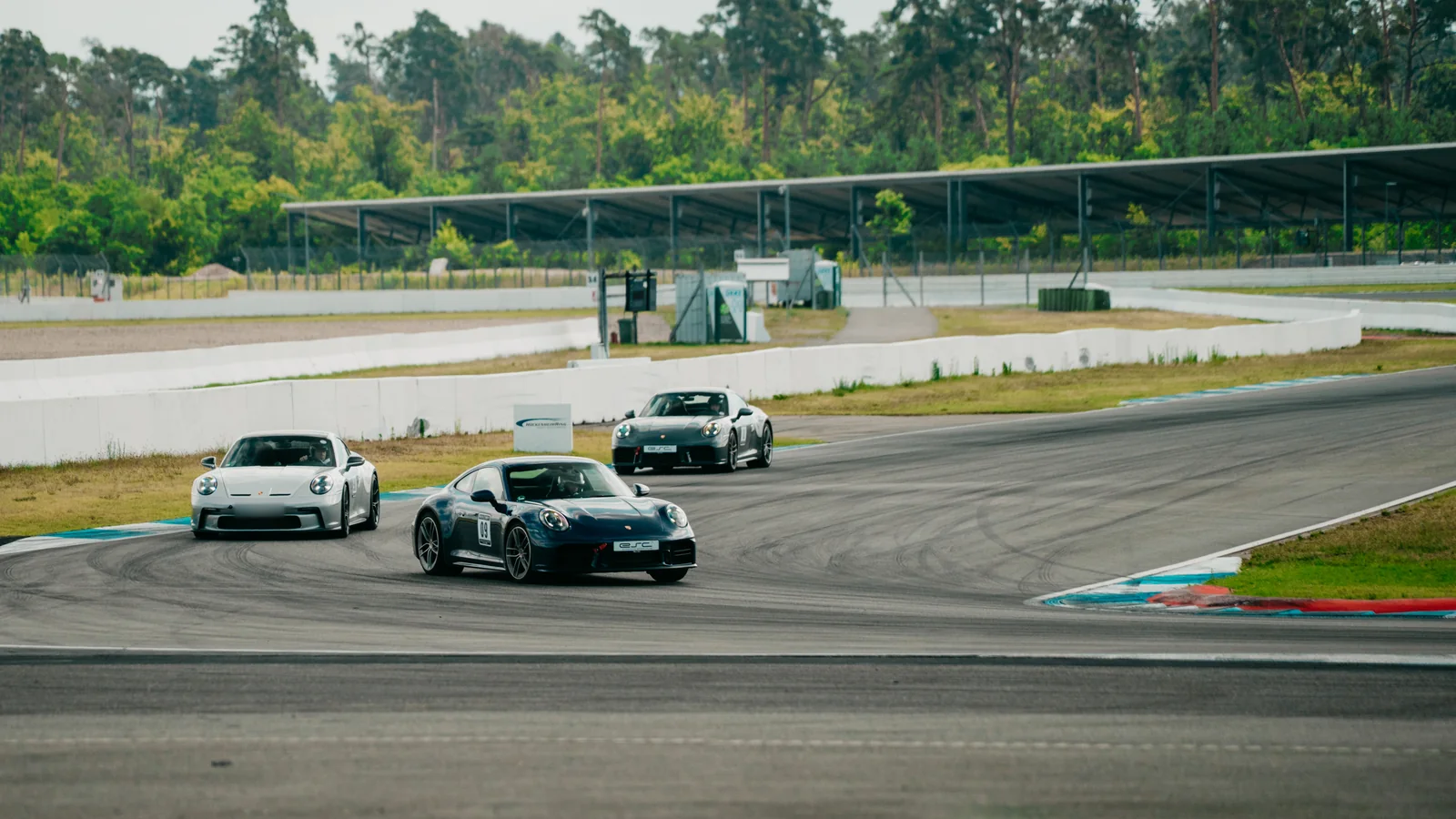 Three Porsche 911 in a corner of the Motodrom at the Hockenheimring