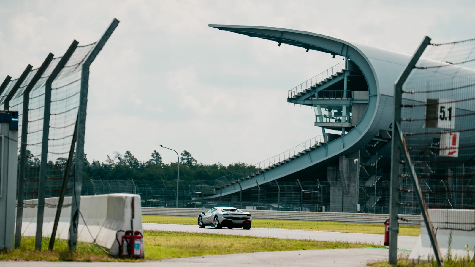 Grandstand architecture at the Hockenheimring with a sports car on the Grand Prix circuit
