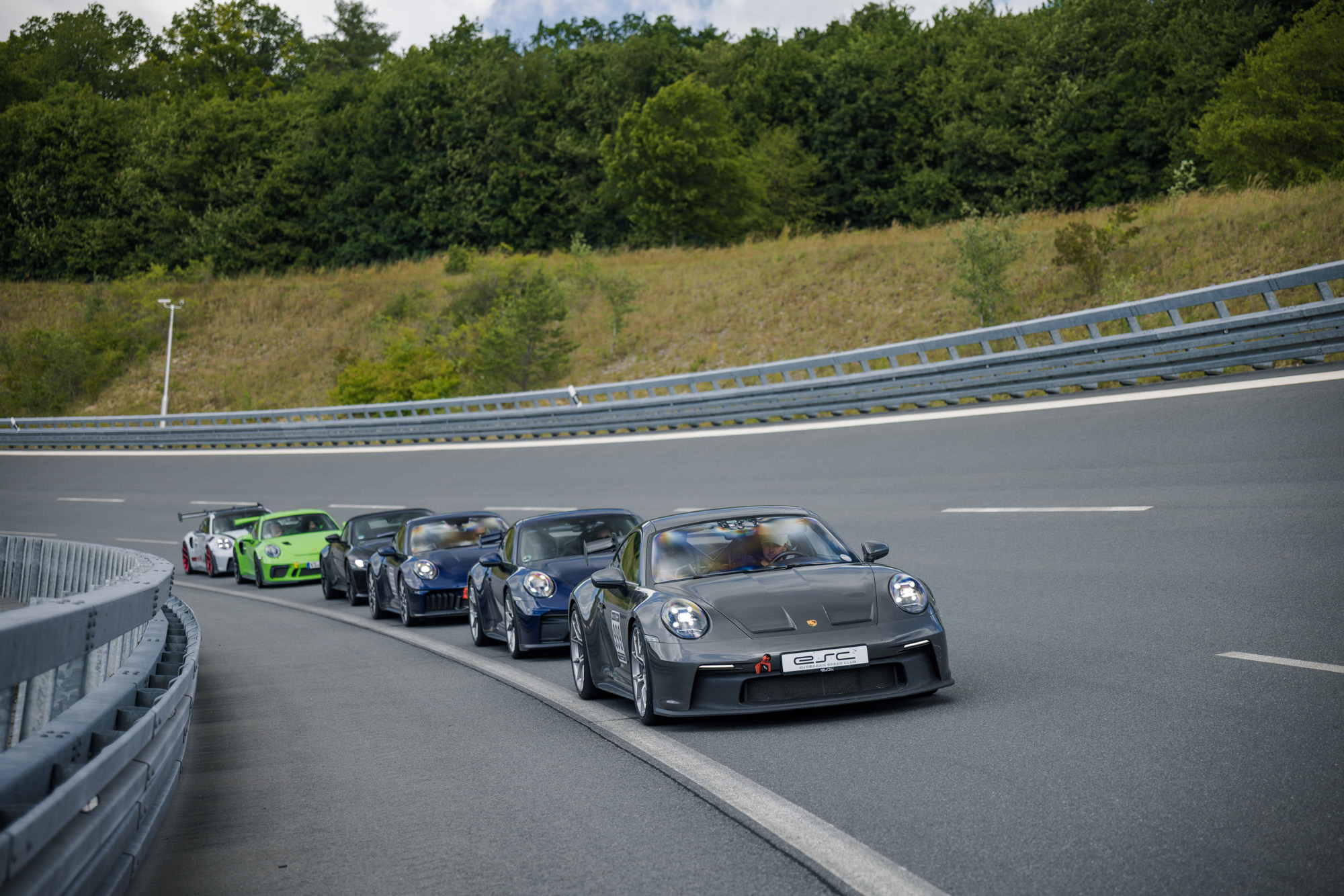 Several Porsche sports cars in a long sweeping corner on the high-speed track at Boxberg during an ESC trackday — race circuits in Germany