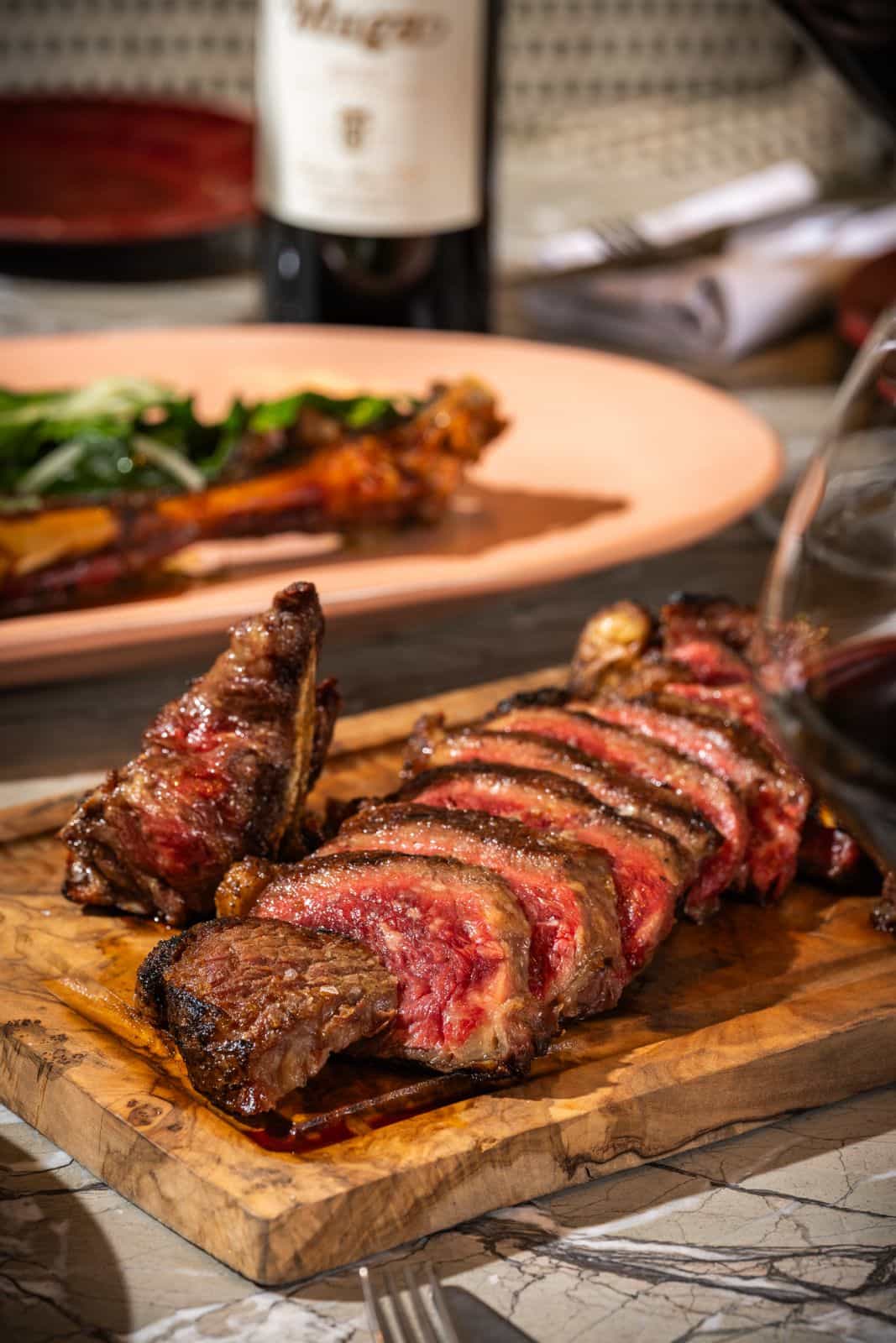 Golden fried croquette served on a blue ceramic plate, topped with sauce and finely chopped chives