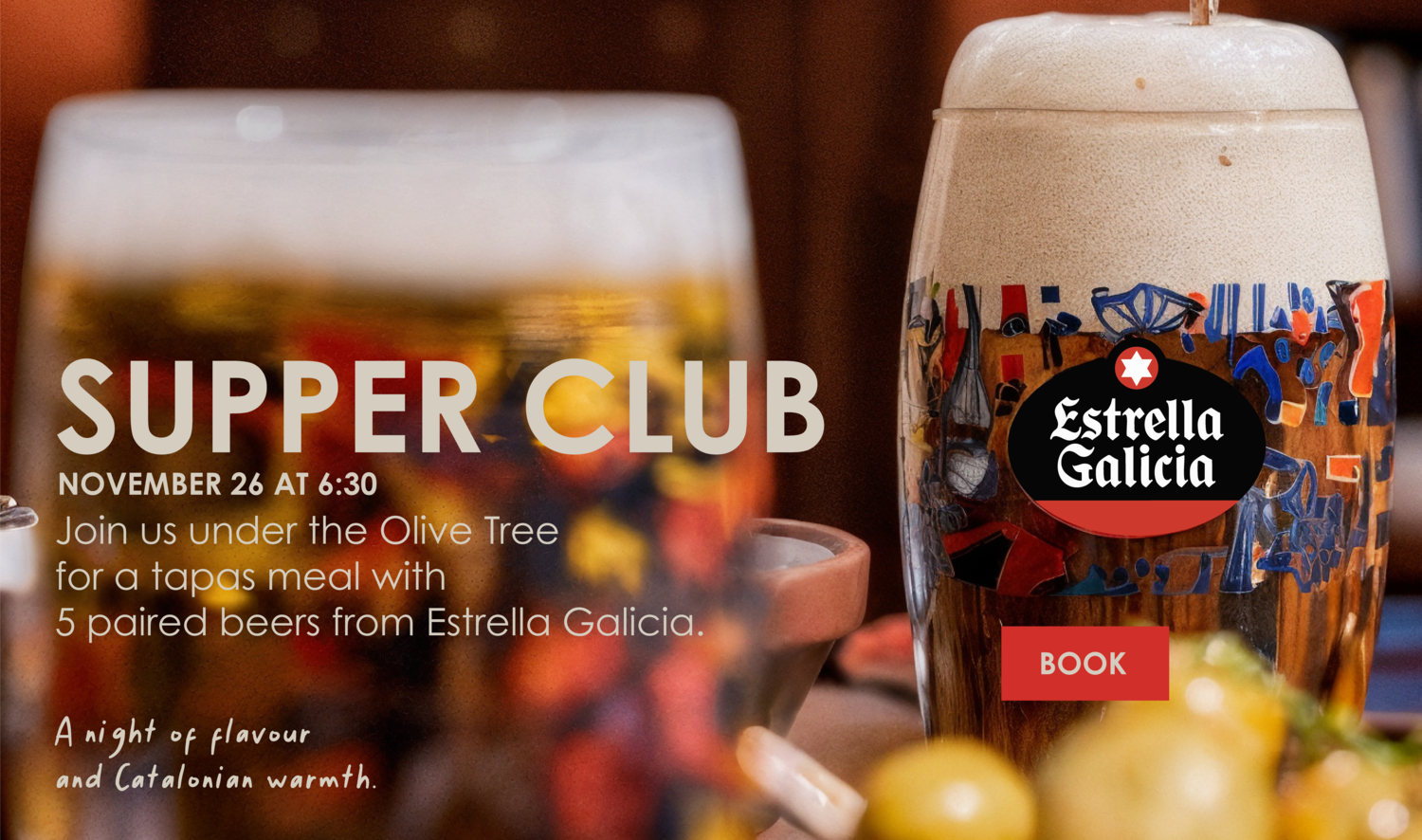 Seafood rice dish with red prawns and mussels, artfully arranged in a paella pan on a marble surface