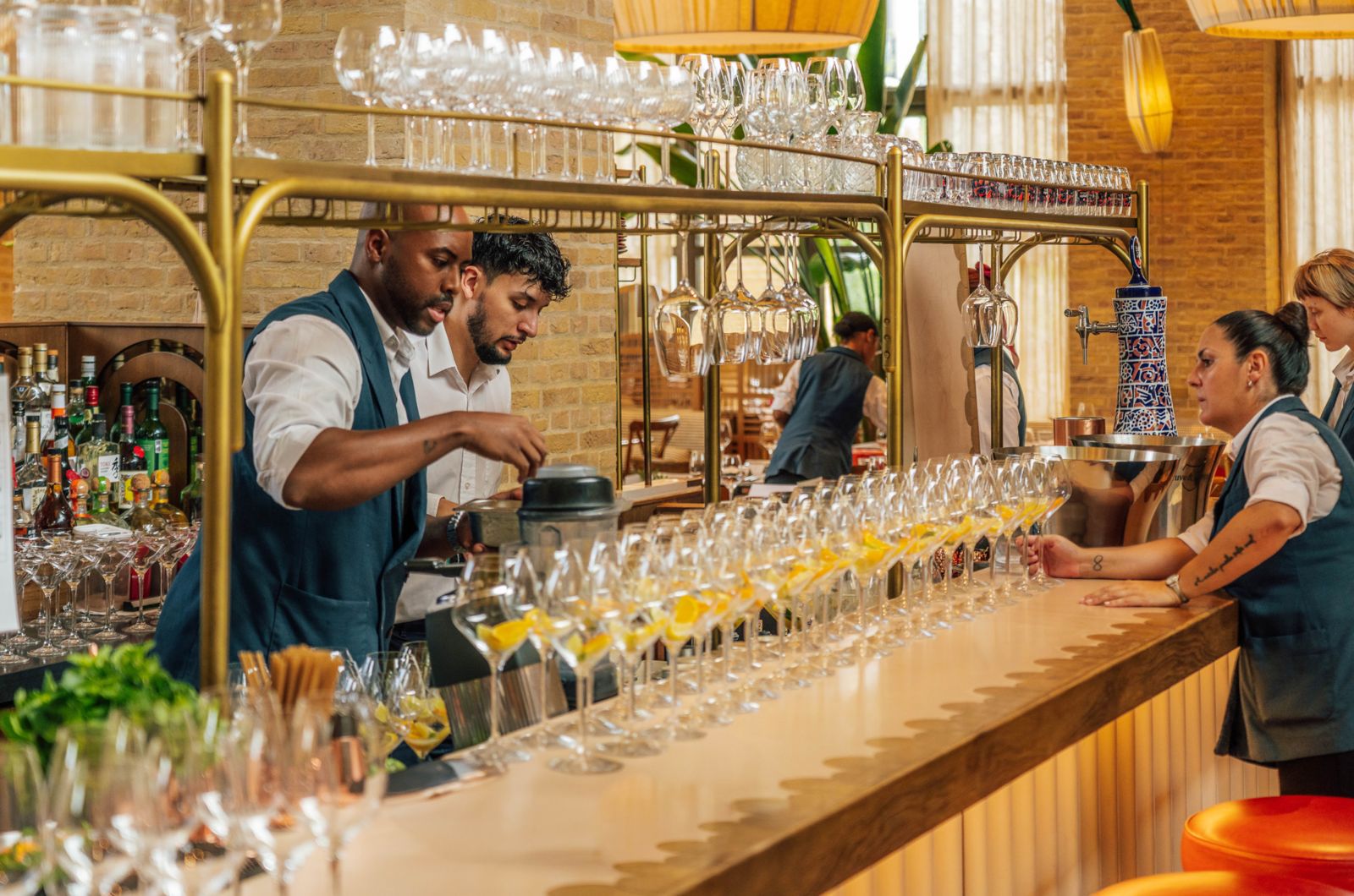 Elegant indoor dining area with soft natural light filtering through sheer curtains, wooden furniture, and intimate table settings