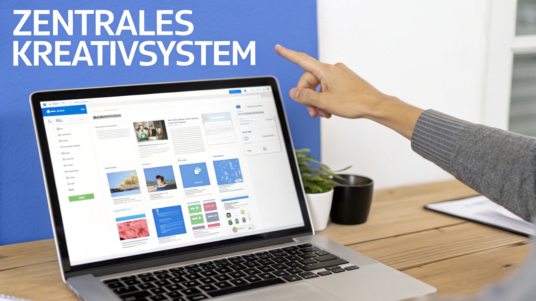 Person zeigt auf Laptop-Bildschirm mit einer Web-Oberfläche, die als 'ZENTRALES KREATIVSYSTEM' beschriftet ist.