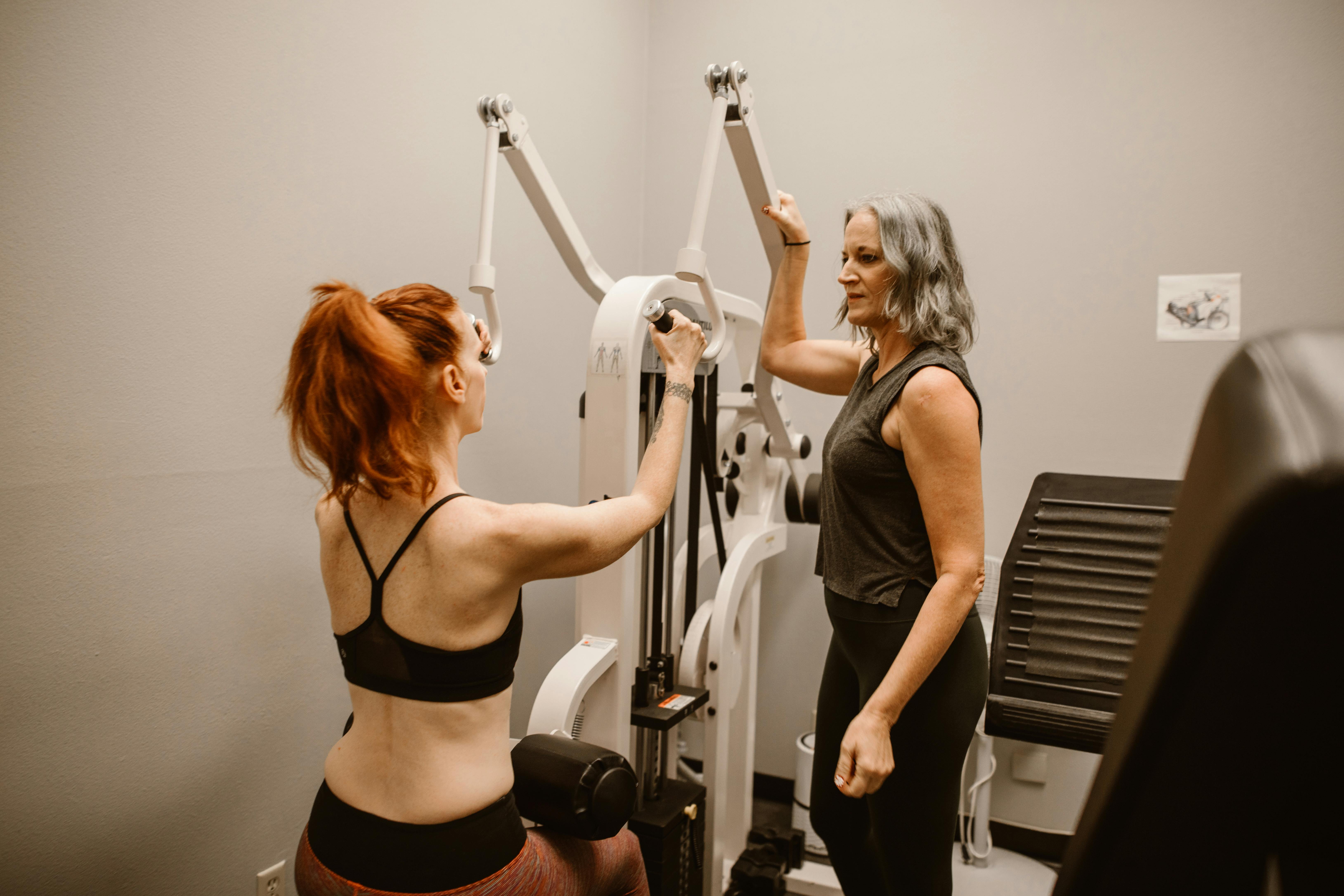 Midlife woman doing a coached dumbbell squat—menopause-friendly strength training at Inspire Health & Fitness Clonmel to protect muscle and bone.