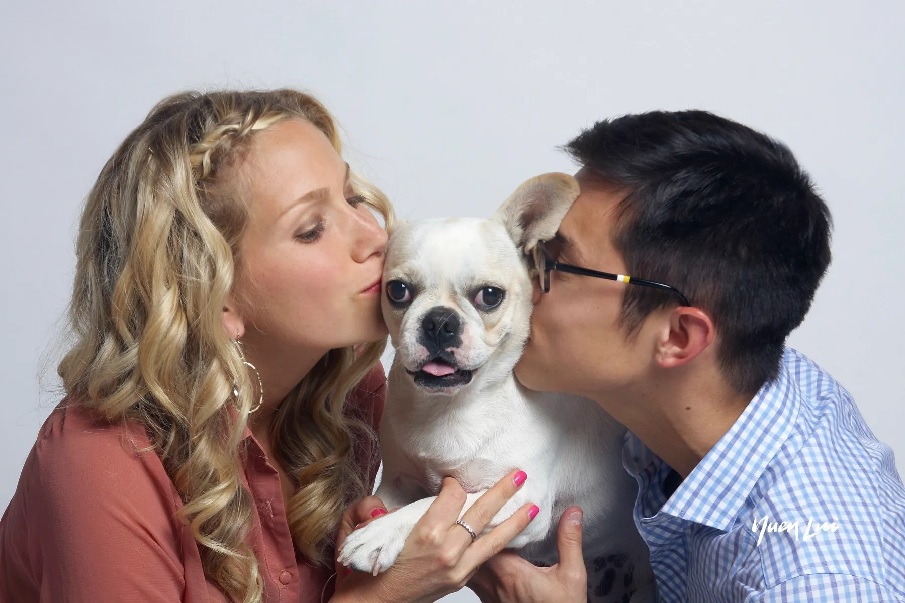 Royal Frenchel family companion being kissed by a couple.