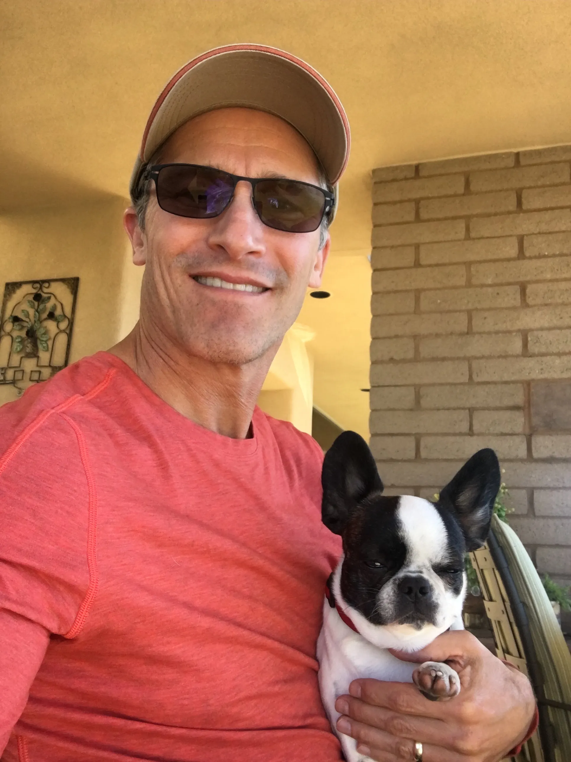 Micro Mini Royal Frenchel being held by its owner at home.