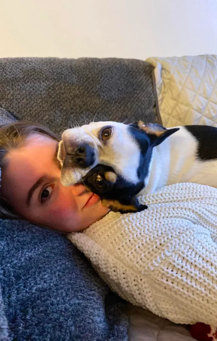 Young girl snuggling with her Royal Frenchel.