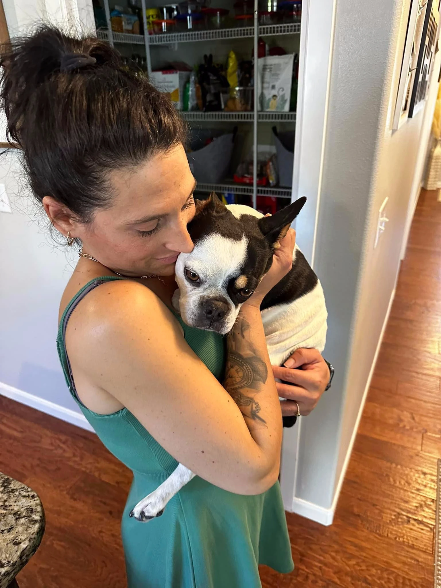 Woman holding and snuggling her Royal Frenchel.