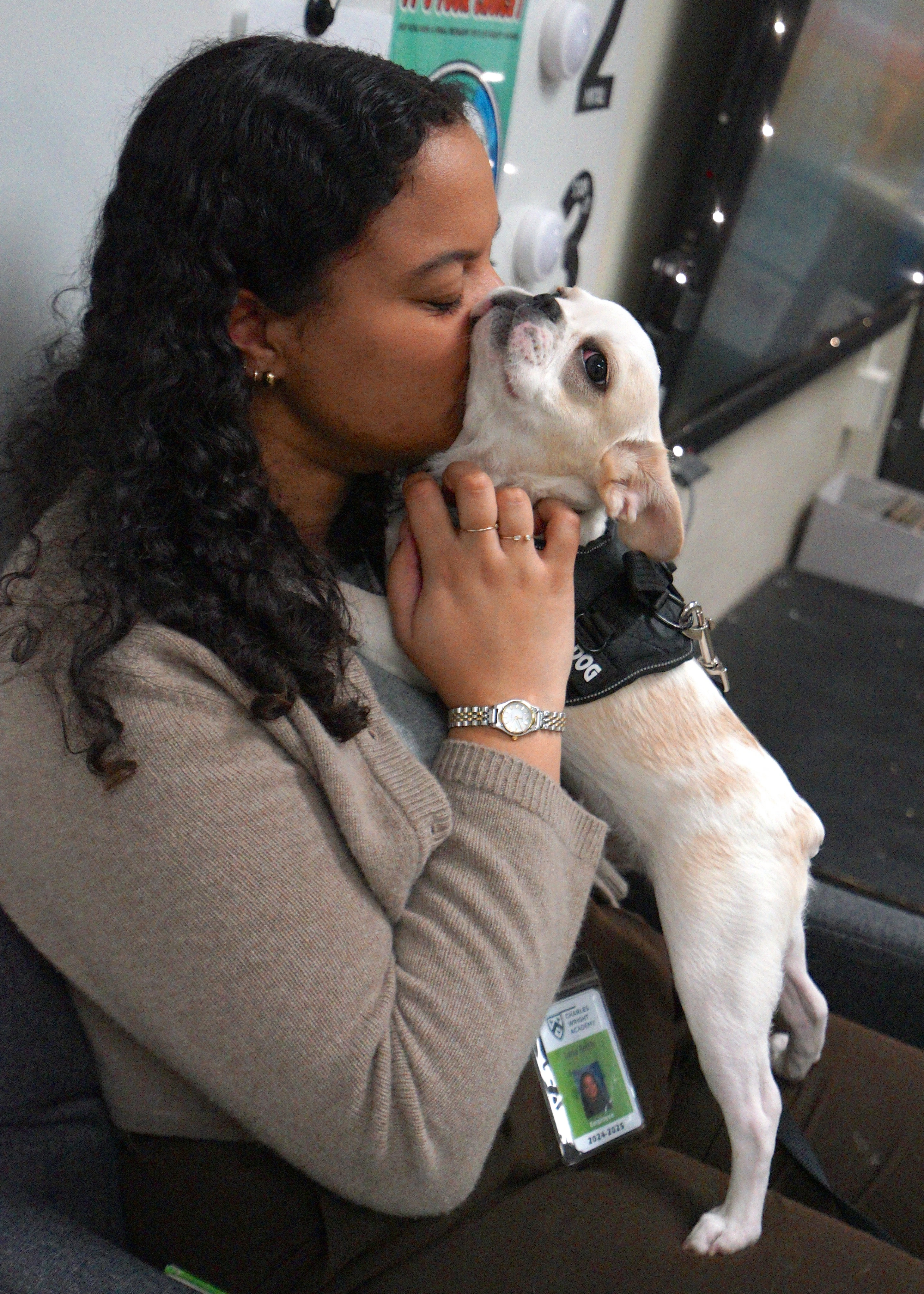 Woman kissing and snuggling her Royal Frenchel.