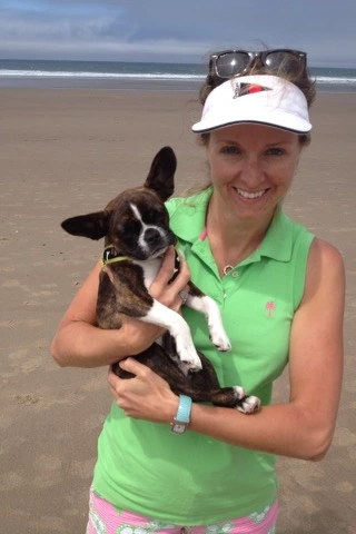 Woman holding her Royal Frenchel at the beach.