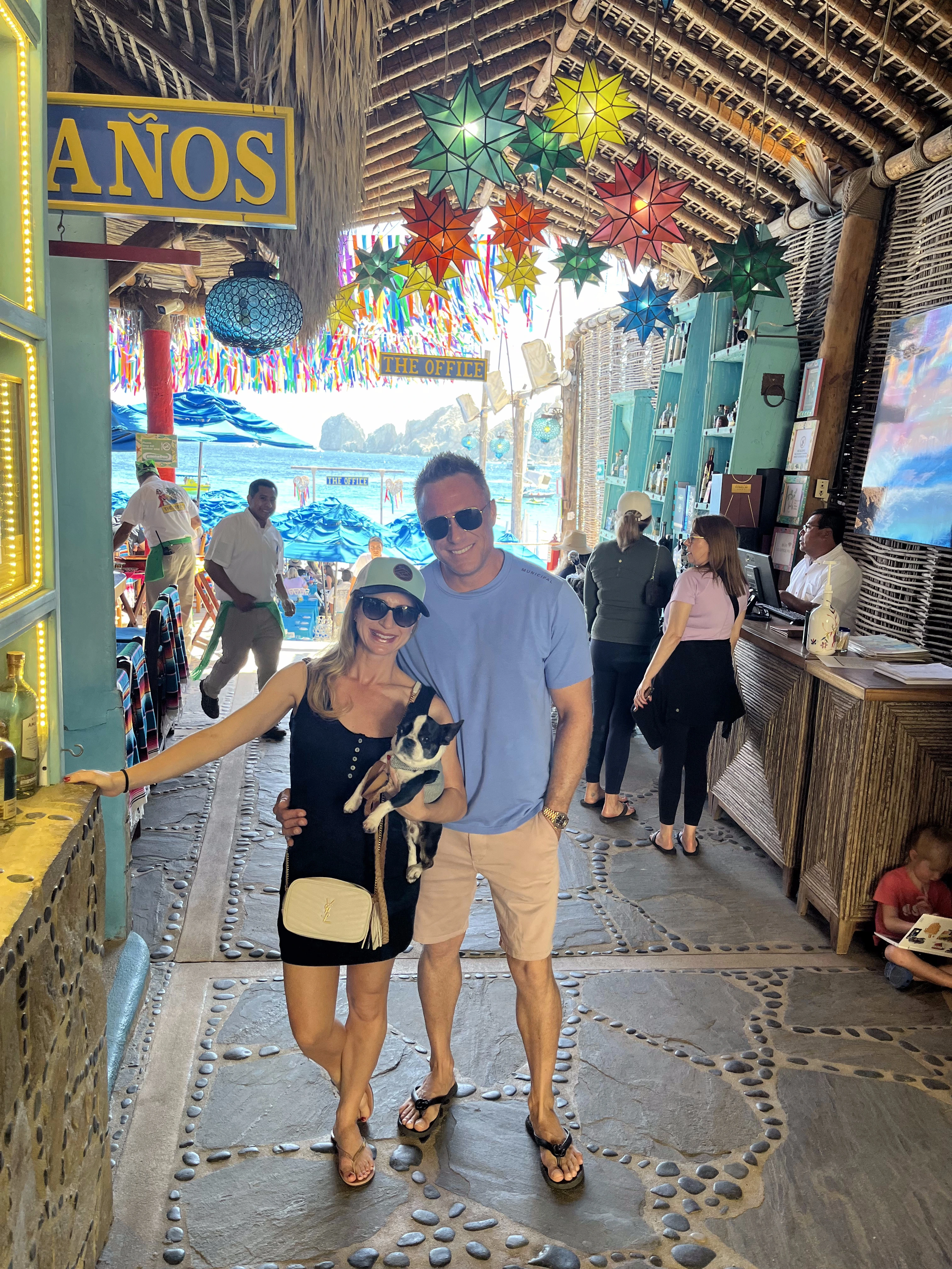 Couple holding their Royal Frenchel while visiting a colorful street market.