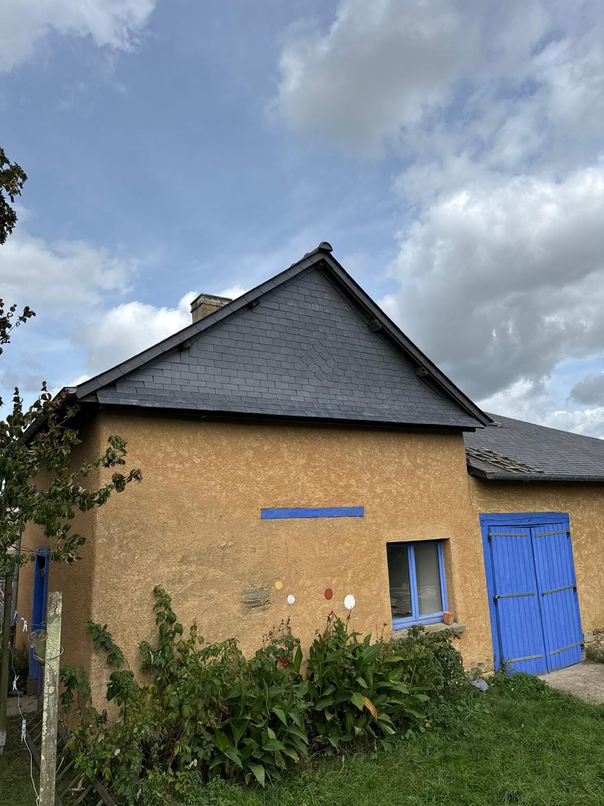 Vue latérale du pignon ardoisé terminé avec cheminée et poinçon à Pacé