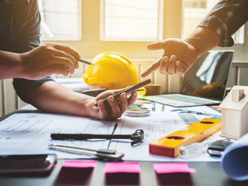 Consulting with Construction Worker