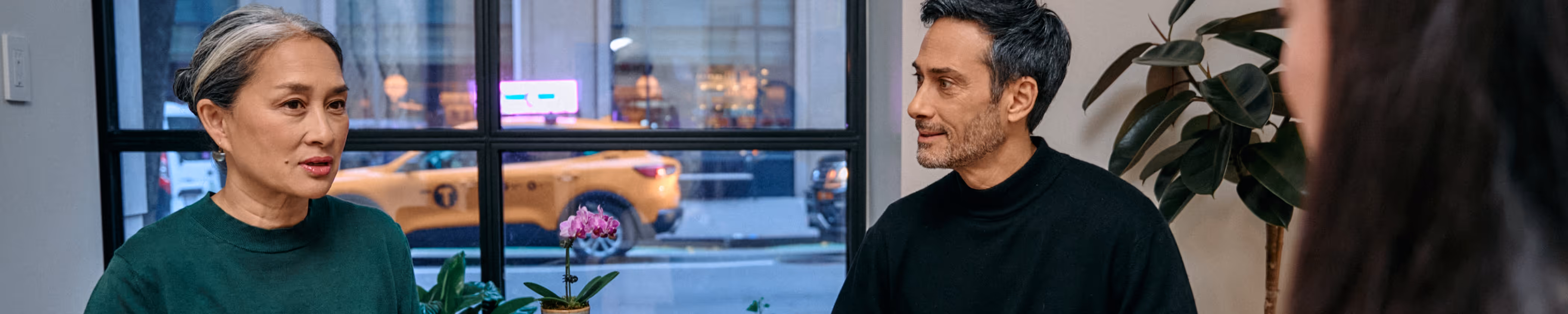 Display banner showing patients interacting with staff at the NYC clinic.