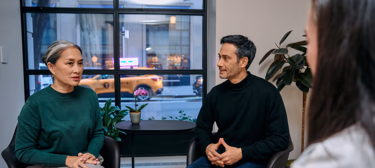 Display banner showing patients interacting with staff at the NYC clinic.