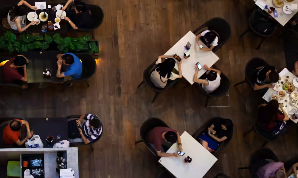 Overhead view of a busy restaurant with diners at tables.