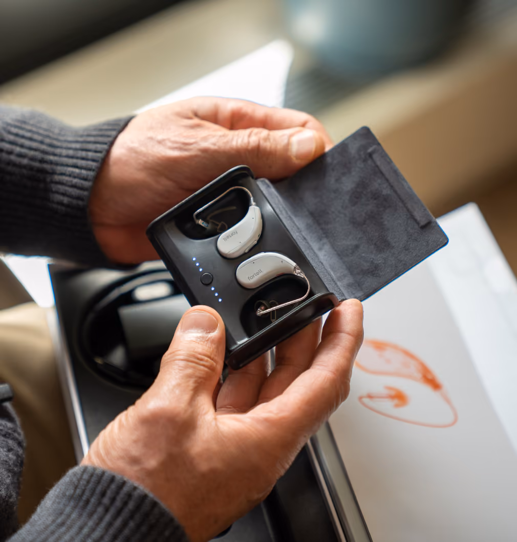 Fortell AI Hearing Aids charging in their portable case.