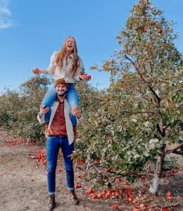 Brooke Hansen, RDH, enjoying time outside with her husband, at an apple orchard.