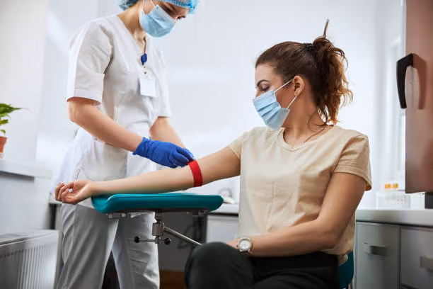 Phlebotomist drawing blood in the medical field. 