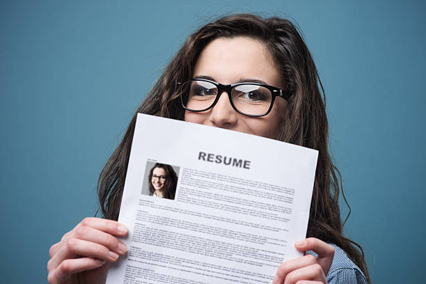 Hygienist holding resume, Person holding resume, Woman holding resume