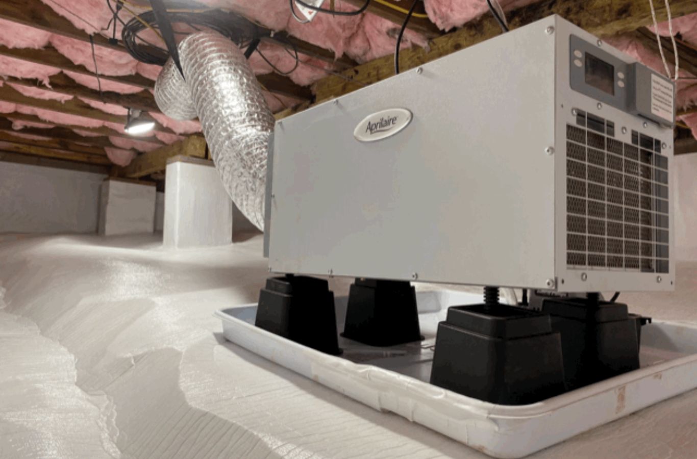 Whole-home dehumidifier on a drain pan with flexible ducting, the type of system installed for Venice, FL homes.