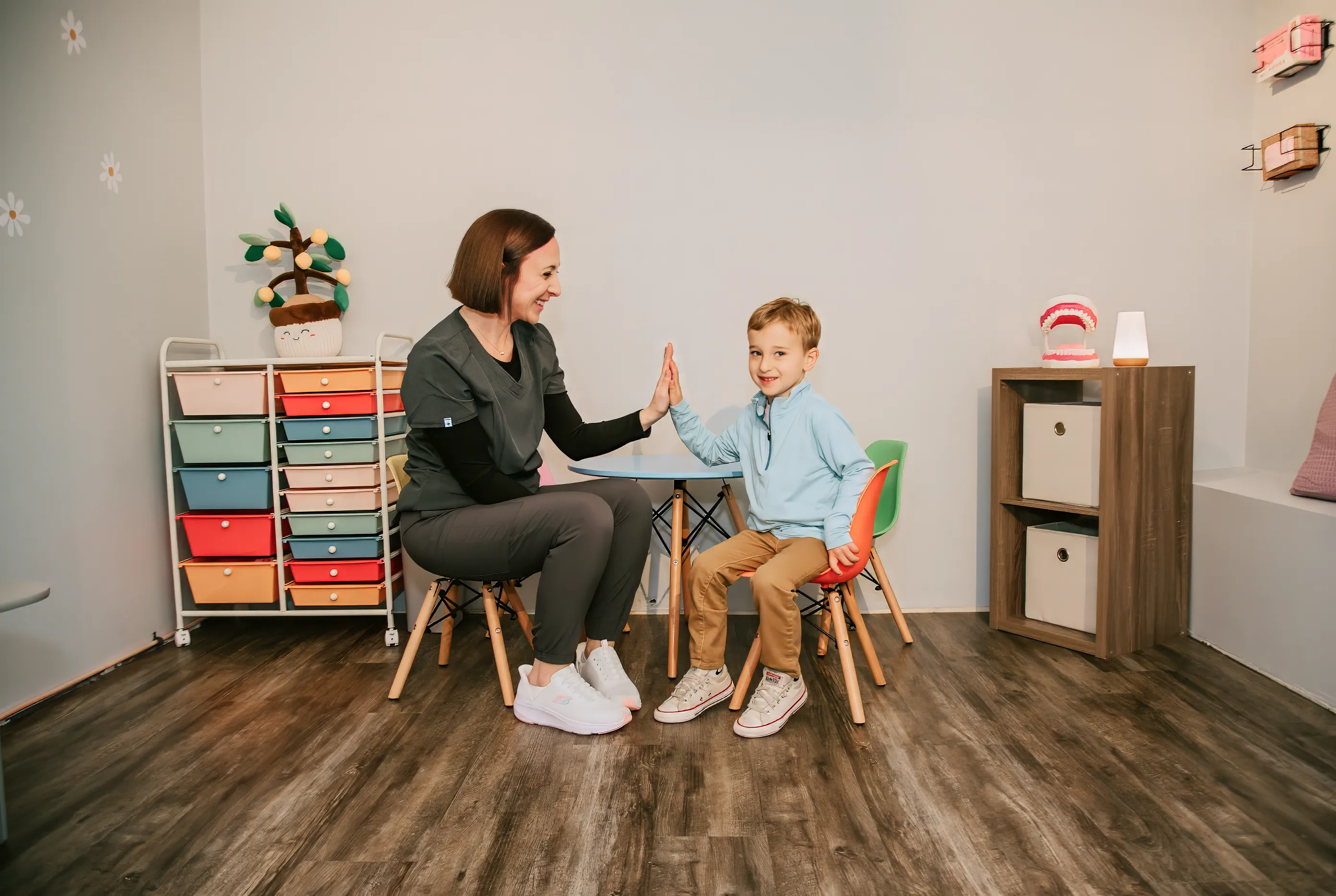Sadie Fullam providing speech therapy to a young child in a calm, supportive setting at Speech and Language Nook.