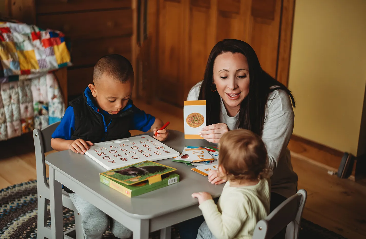 Sadie Fullam leading a speech therapy session with two children, building communication skills through interactive activities.