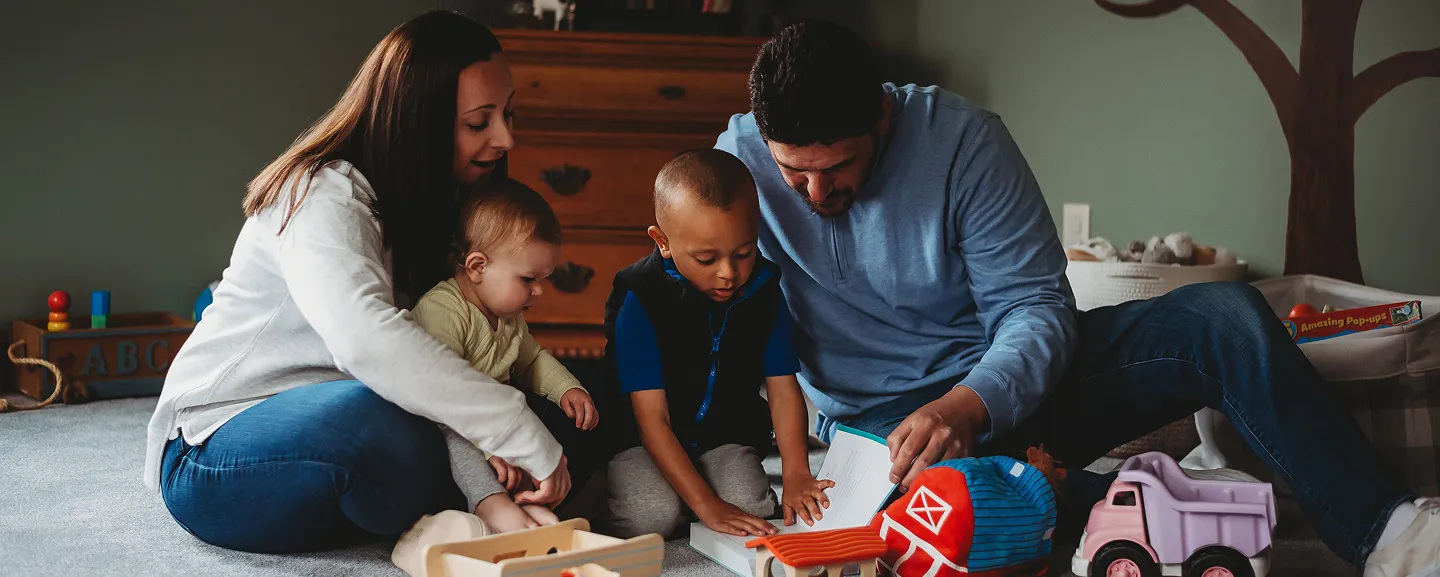 Sadie Fullam with a parent and two children, welcoming families to Speech and Language Nook, a supportive center for speech and educational services.