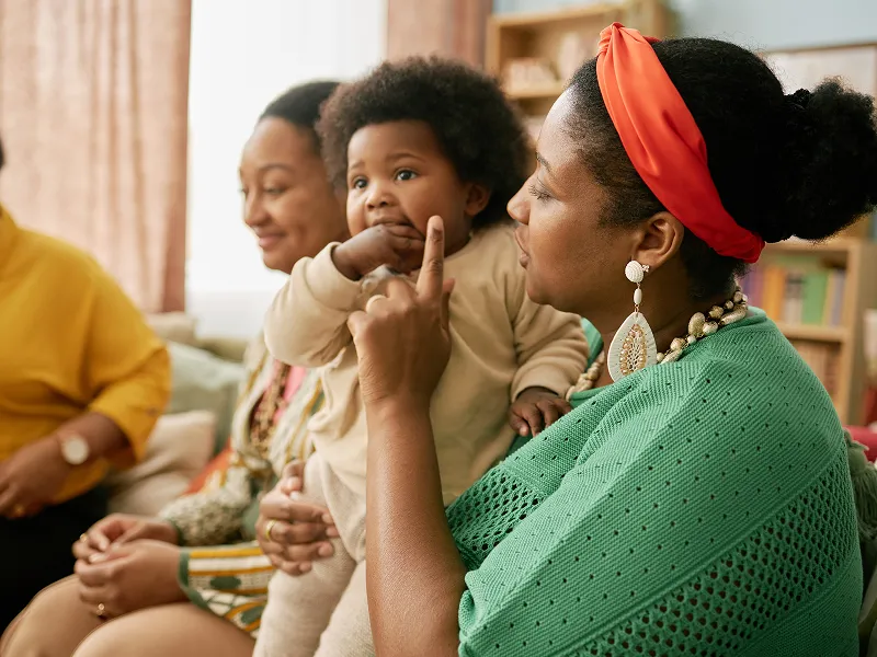 Image of mom and child in group learning session