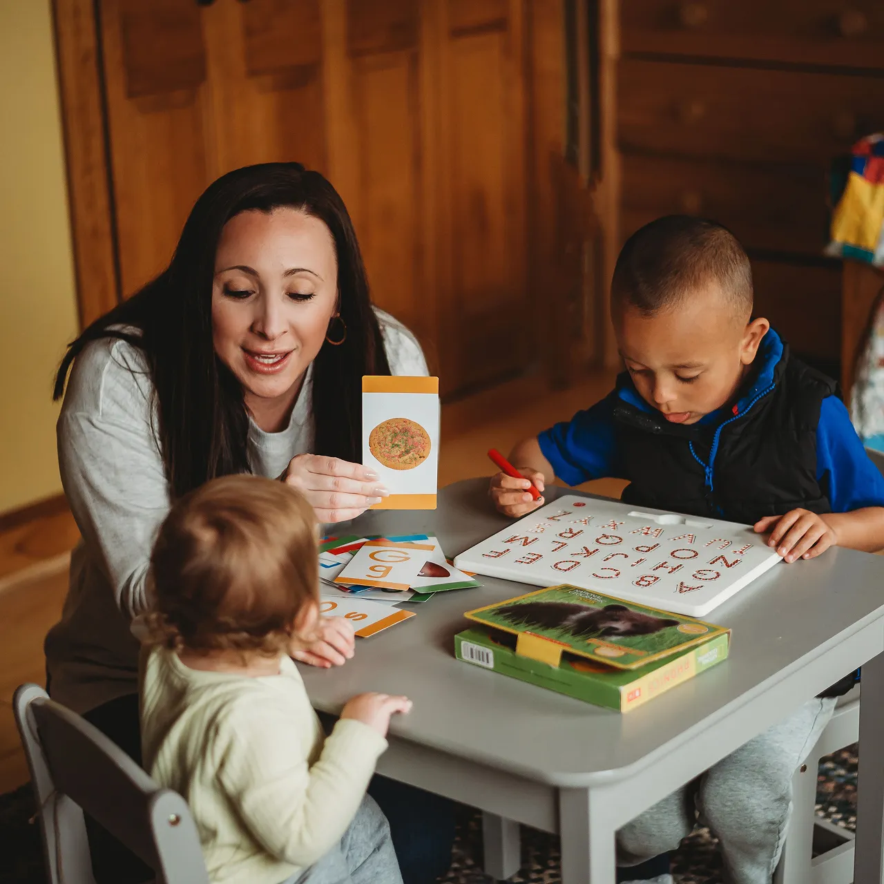 Sadie Fullam conducting a speech language therapy session with two children, focusing on developing communication and social skills.