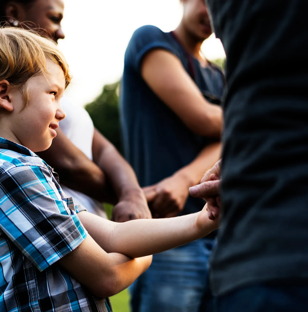 Young boy engaging confidently in a group setting, demonstrating positive social language and emotional development skills.