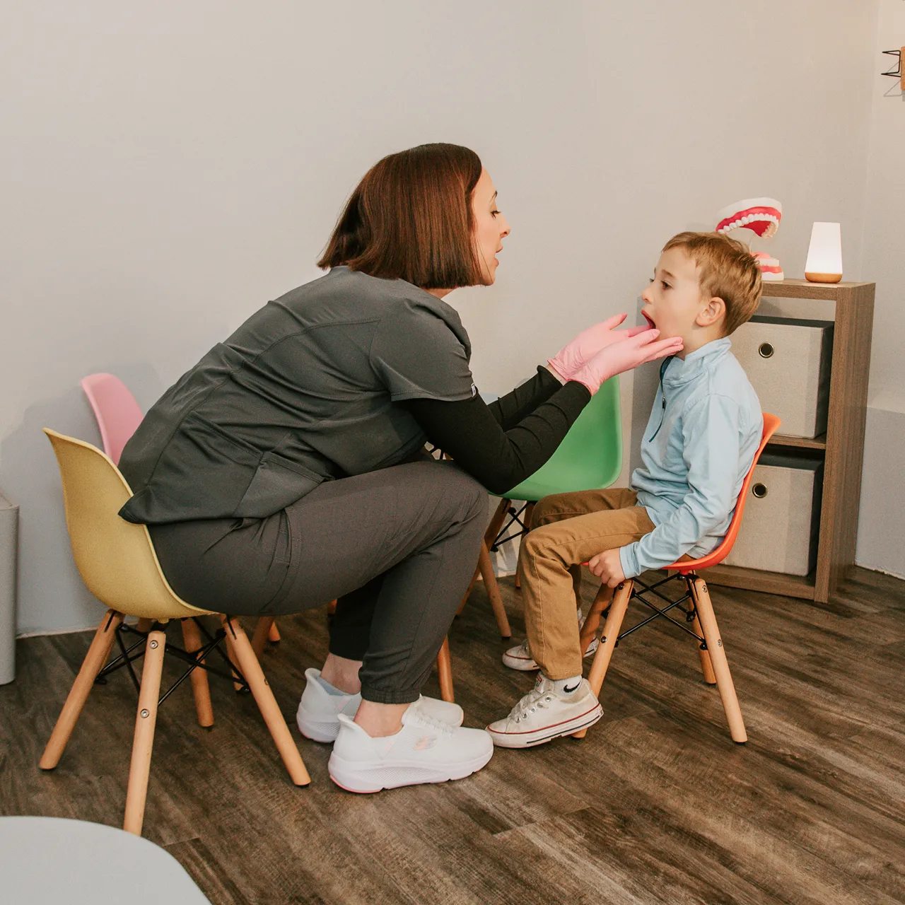 Sadie Fullam conducting a speech language therapy session with two children, focusing on developing communication and social skills.