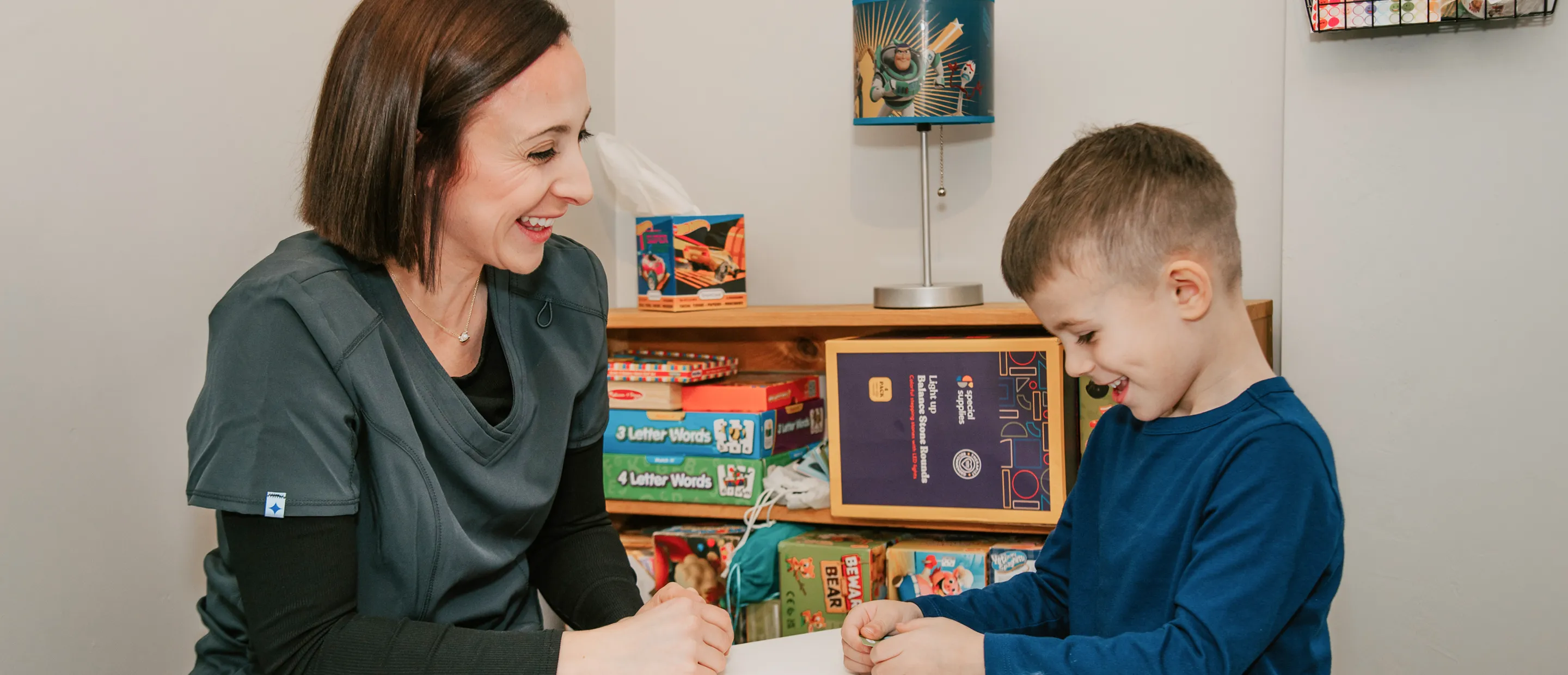 Sadie Fullam with a parent and two children, welcoming families to Speech and Language Nook, a supportive center for speech and educational services.