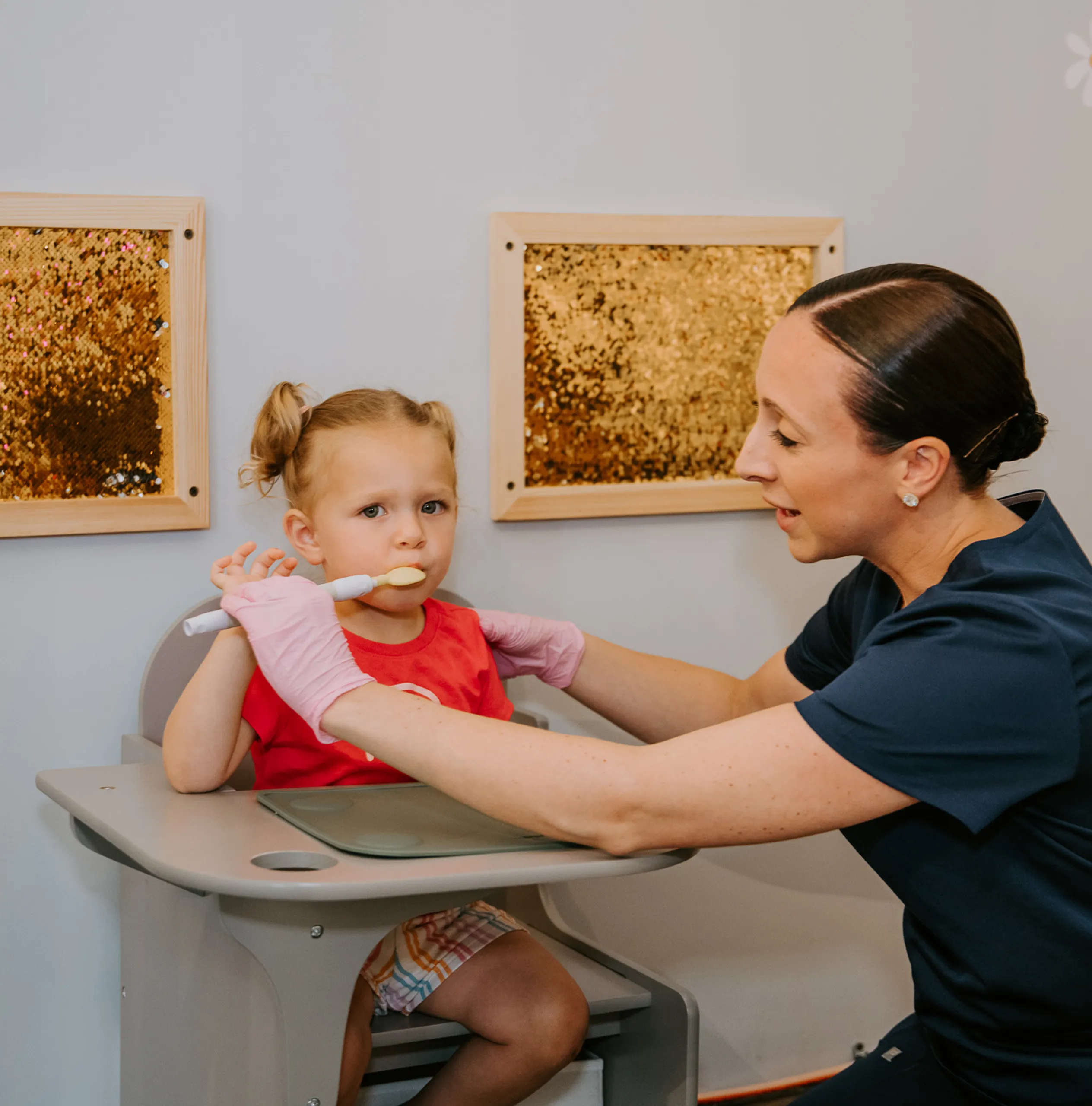 Sadie Fullam conducting a speech language therapy session with two children, focusing on developing communication and social skills.