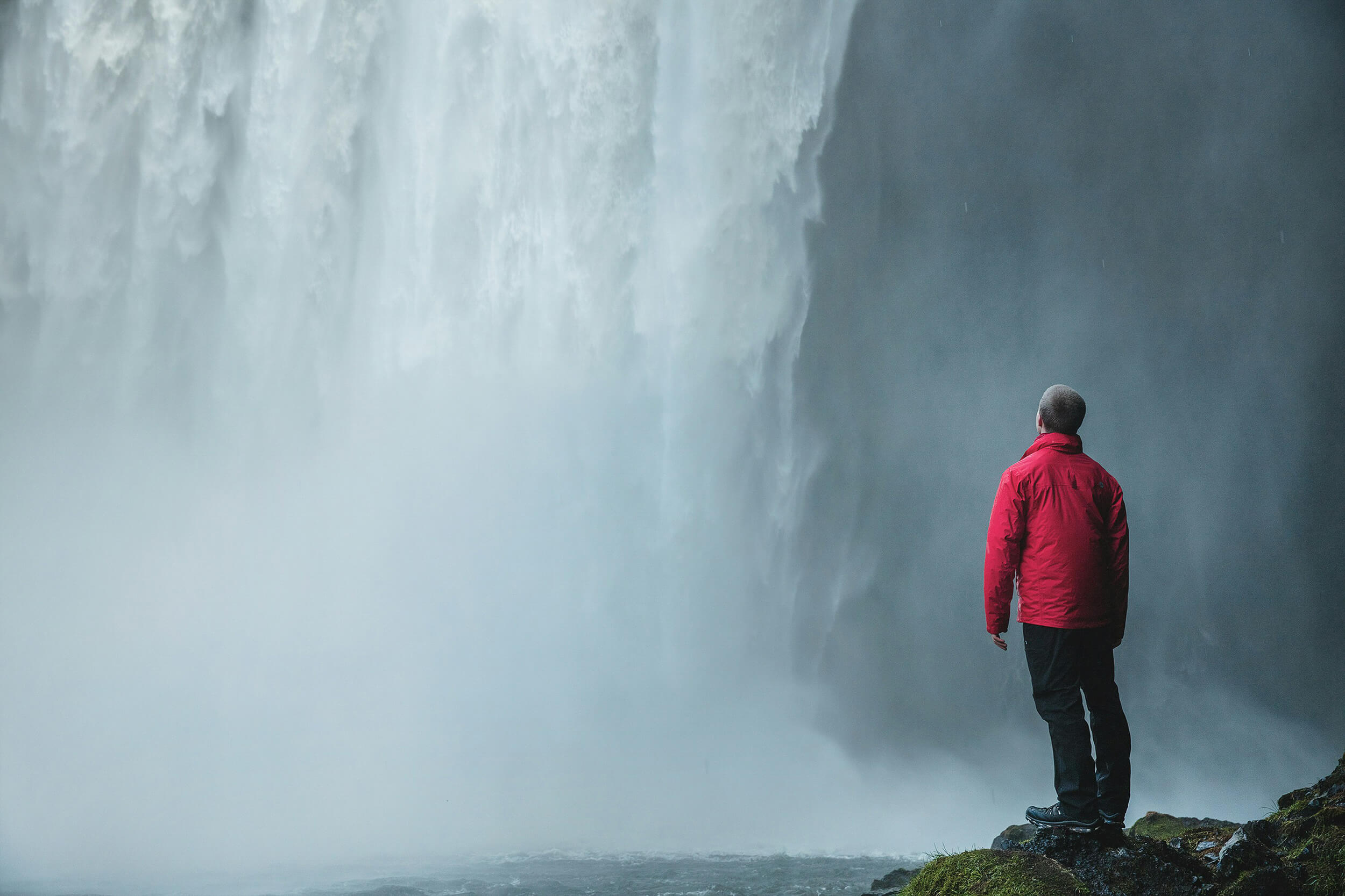 Man watching a beautiful waterfall