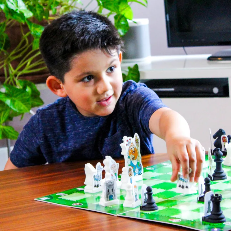 Young boy learning chess with Chess at Three's engaging story-based chess set