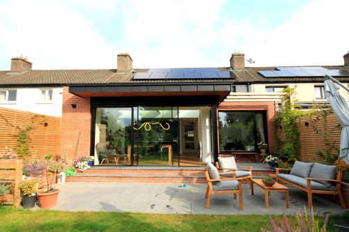 outdoor shot of a garden facing the back of a home extension