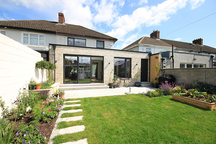 outdoor shot of a garden facing the back of a home extension