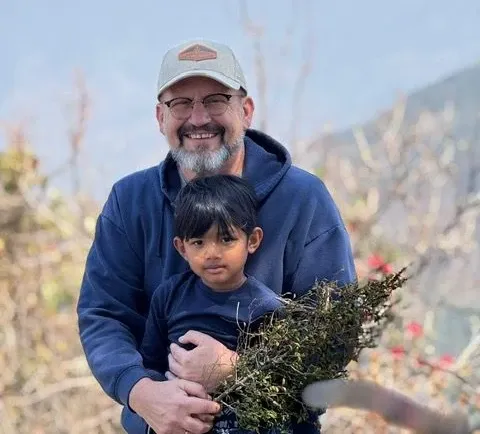 man holding child in arms