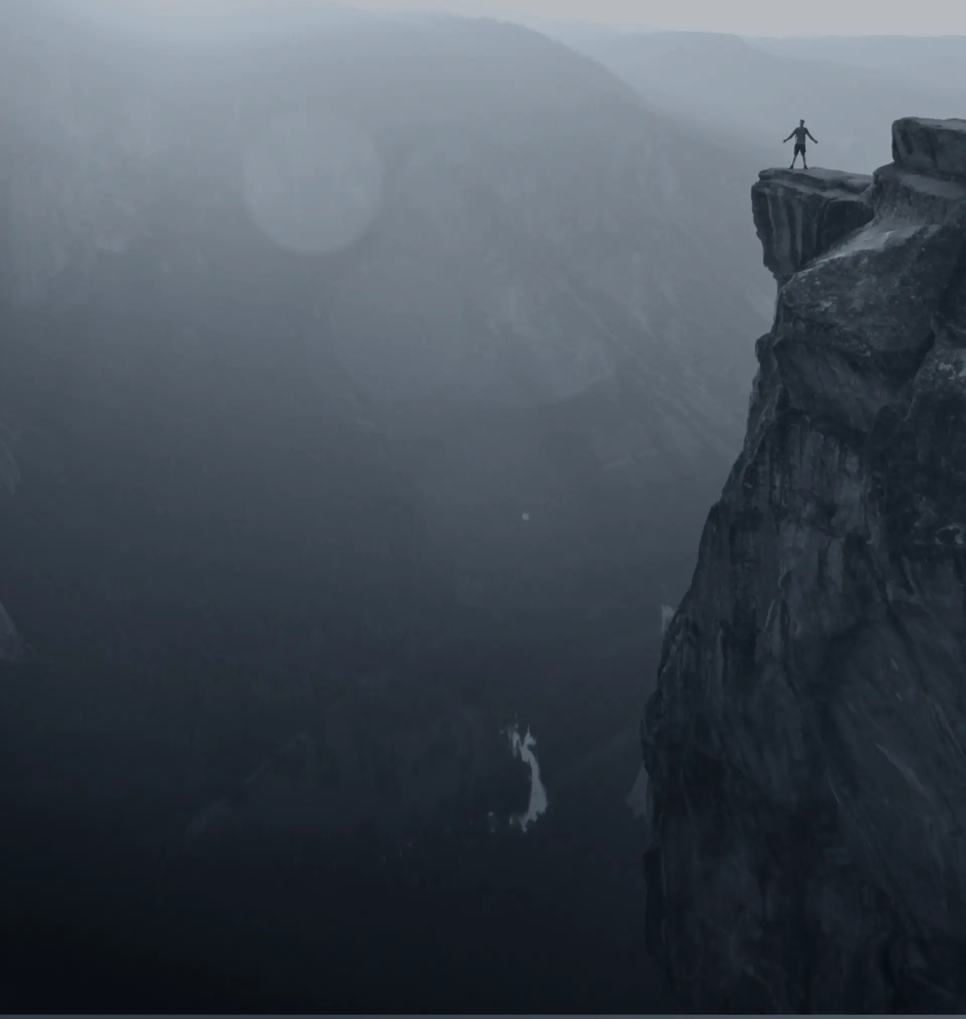 person standing on edge of rock cliff